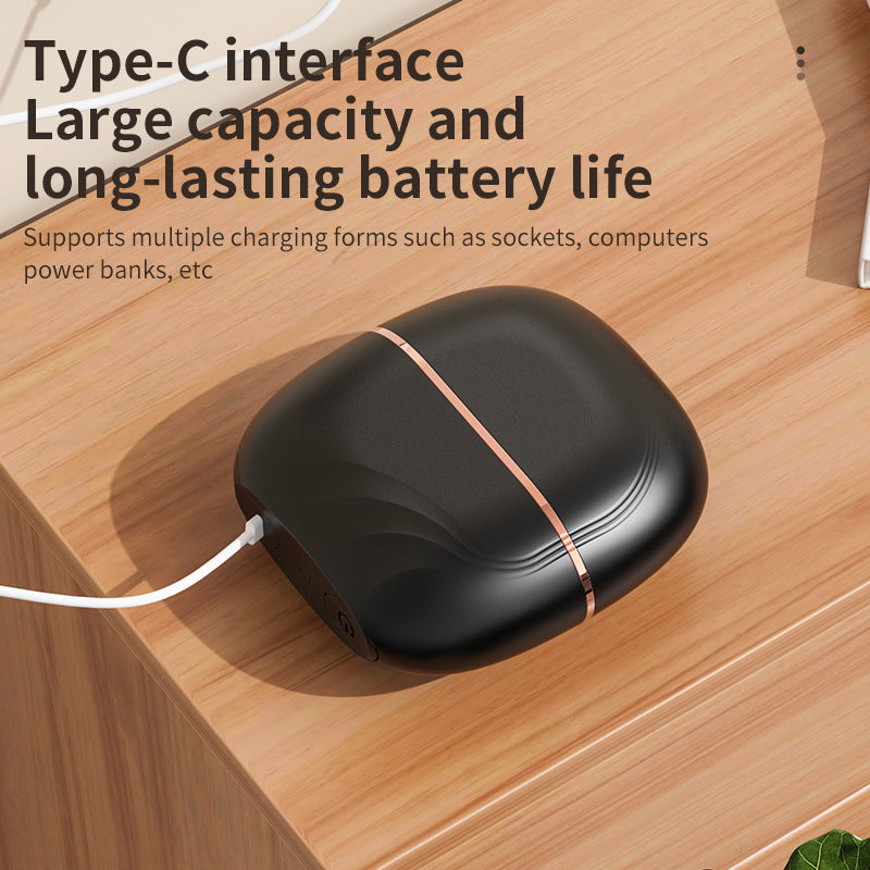 The comb charging over USB-C on a wooden desk